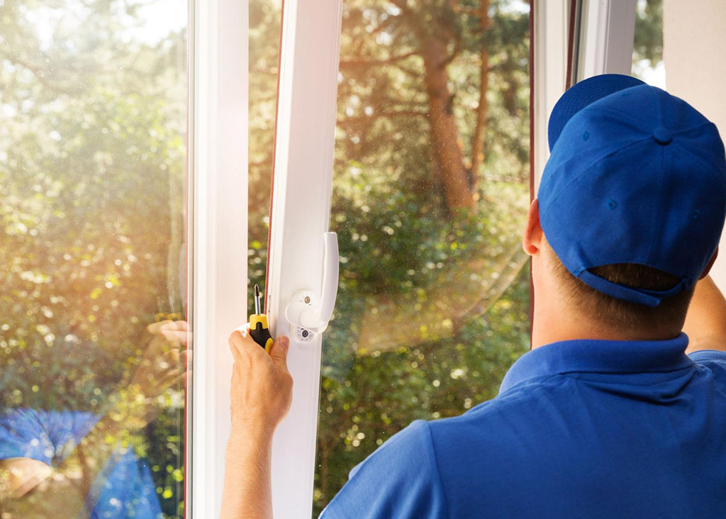 A window installer getting to work by installing a window