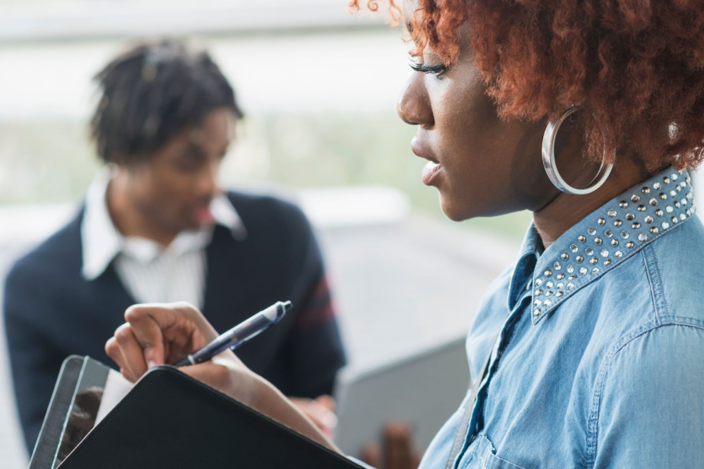  Two energy testers write their findings on notepads. 