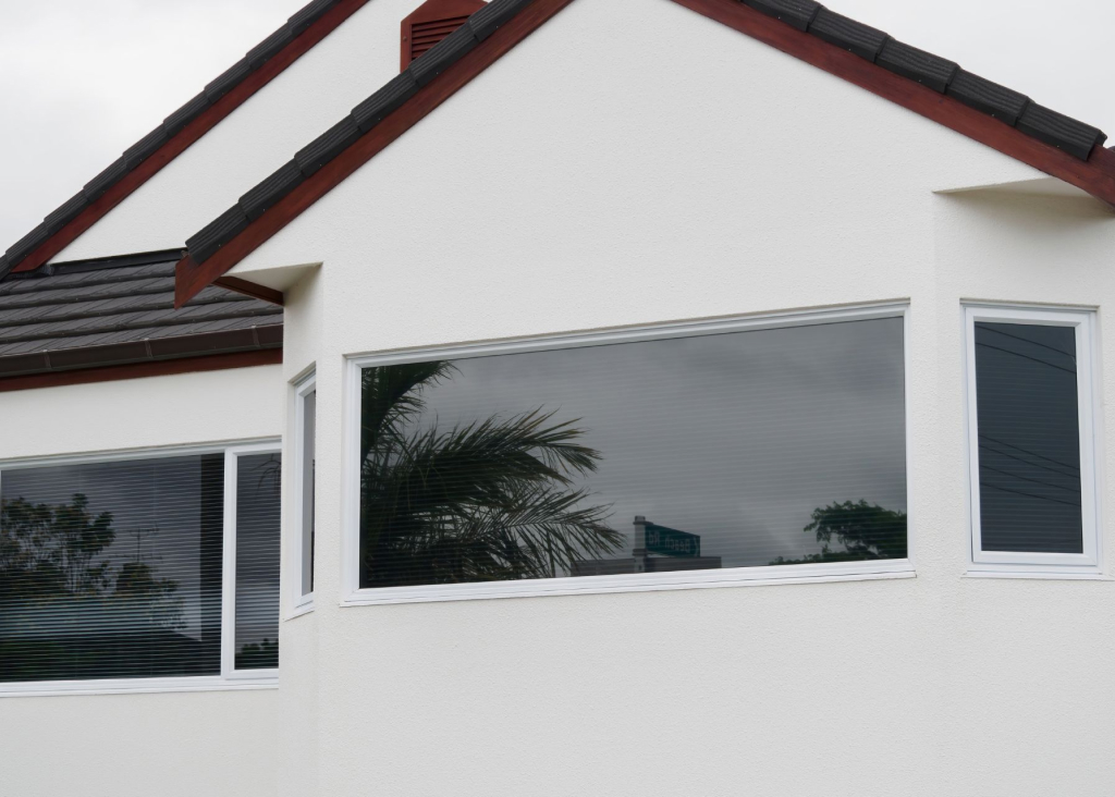 A modern white-walled house with a canted bay window