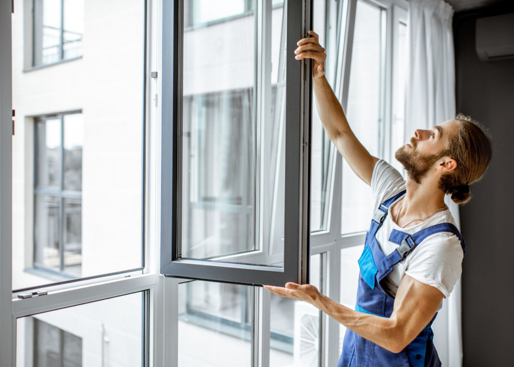 A window installer checking an open casement window